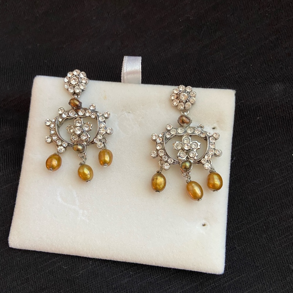Rhinestone earrings with gold colored stones.